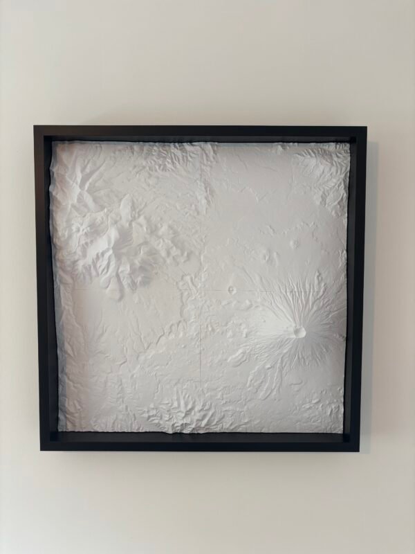 Front view of a white four-tile volcanic terrain map mounted in a deep black frame